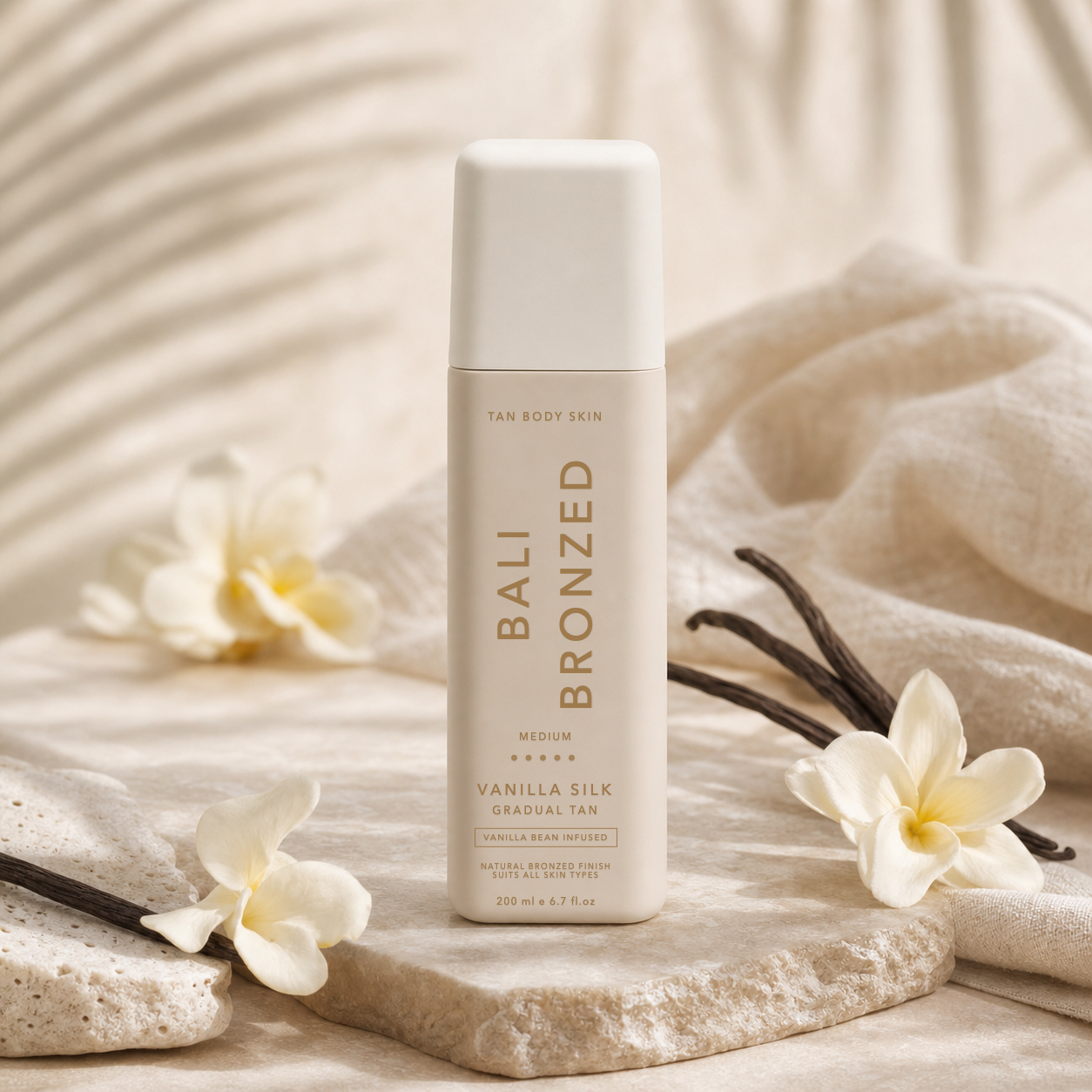Vanilla silk gradual tan bottle with vanilla beans and cream flowers